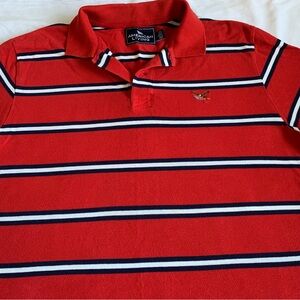 Like new, AMERICAN LIVING polo size L red with white and blue strips.